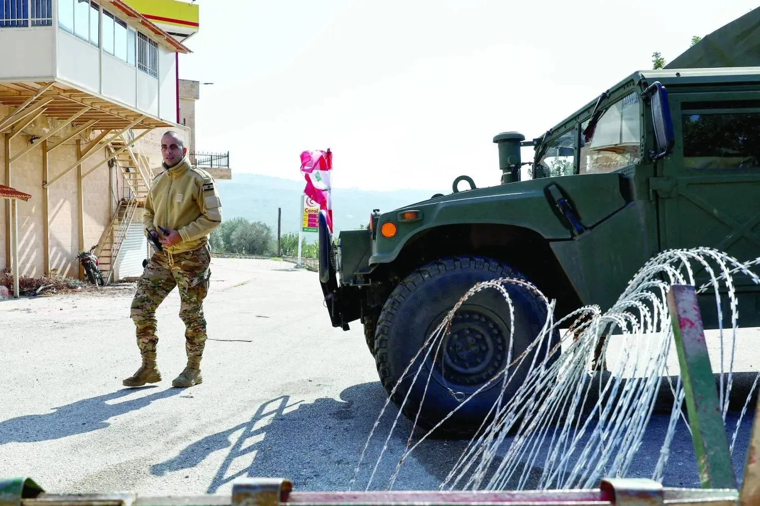 A Lebanese soldier stands beside a military vehicle in the southern town of Deir Mimas (Reuters)