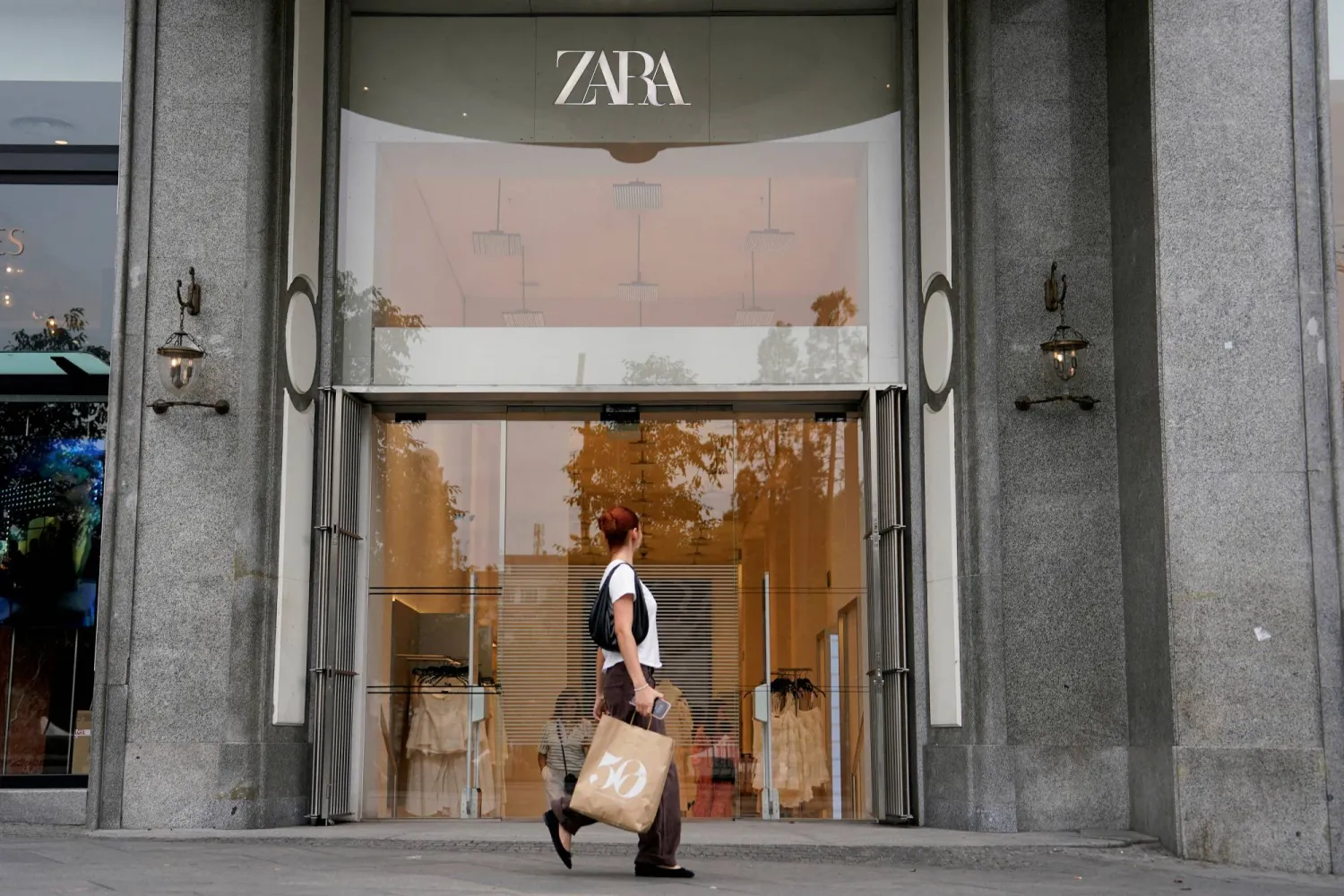 FILE PHOTO: A person walks by a Zara store in Plaza de Espana in Madrid, Spain, June 11, 2025. REUTERS/Ana Beltran/File Photo
