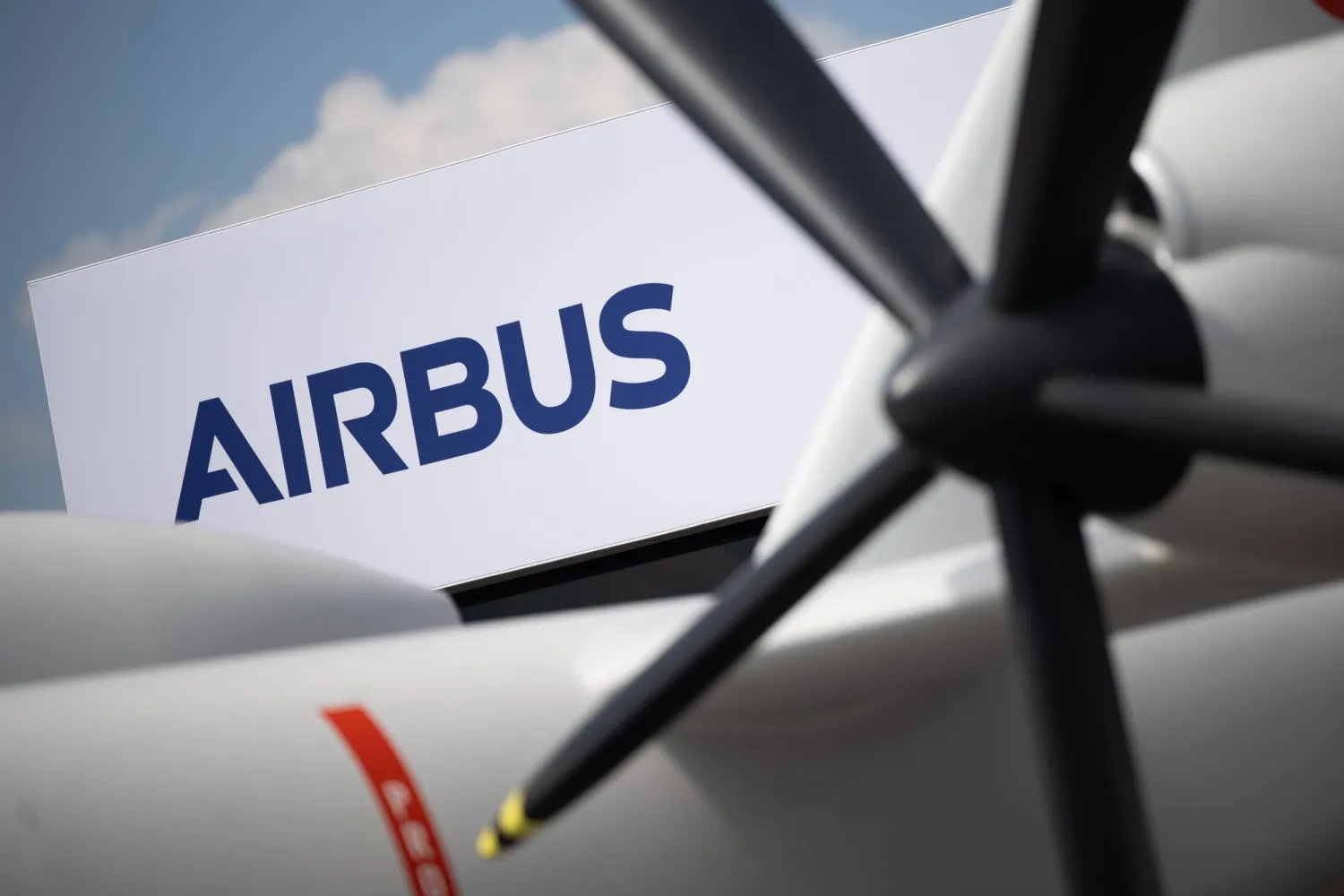 FILED - 06 June 2024, Brandenburg, Schoenefeld: The Airbus logo can be seen behind a model of the Eurodrone during the International Aerospace Exhibition (ILA) at Berlin Brandenburg Airport (BER). Photo: Sebastian Gollnow/dpa