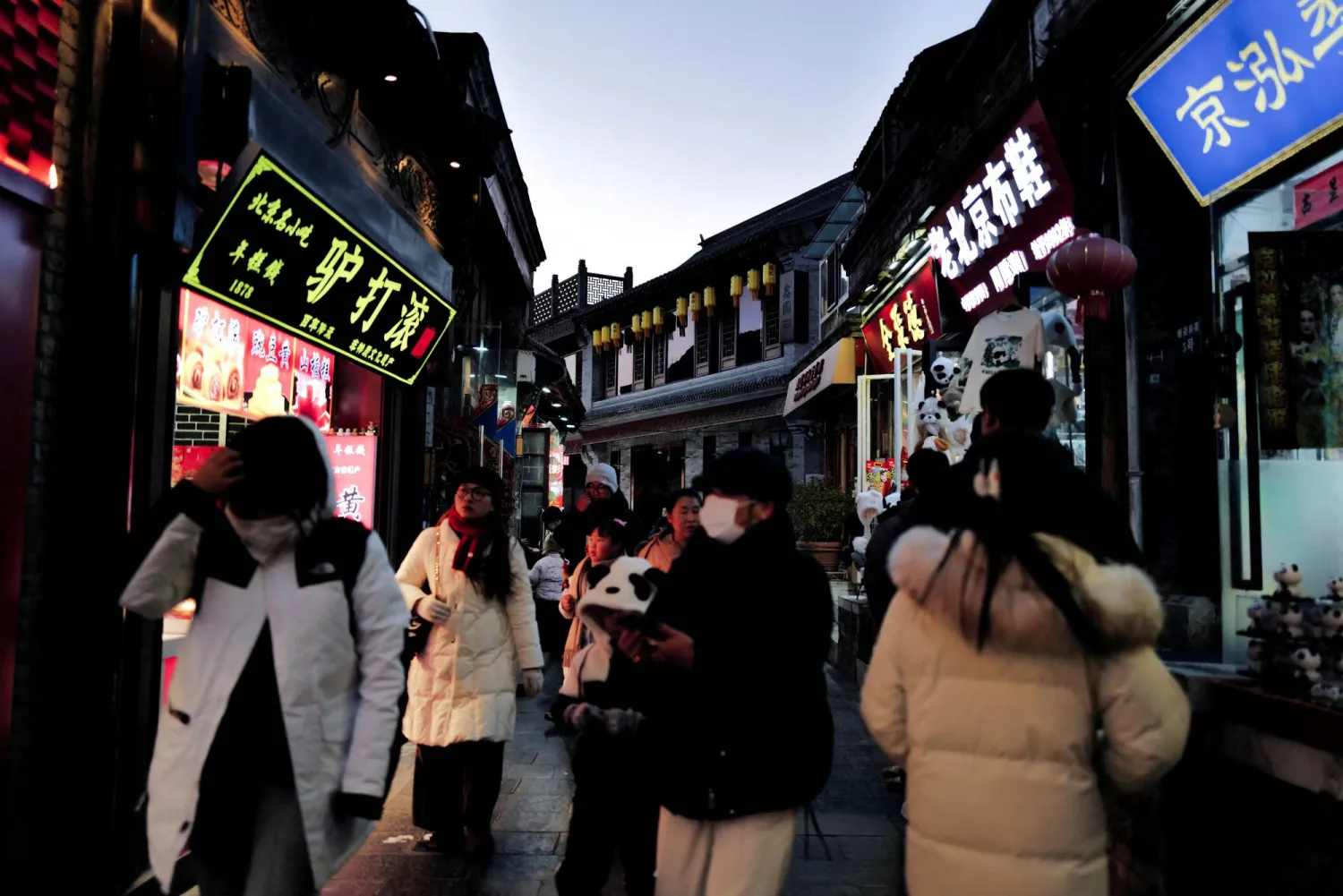 People walk in a commercial street at the historical Shichahai district in Beijing, China, December 3, 2025. REUTERS/Sarah Meyssonnier
