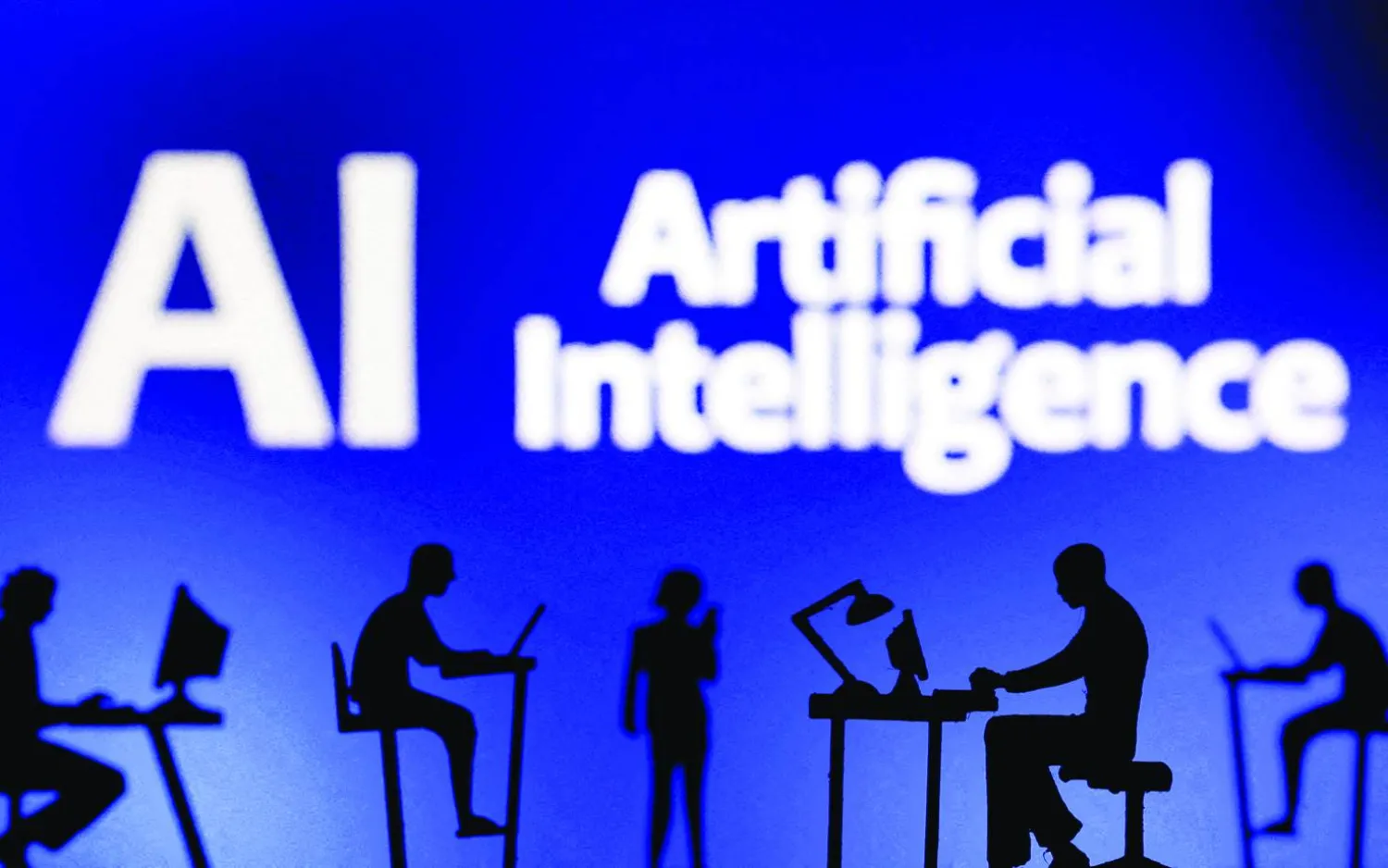 FILE PHOTO: Figurines with computers and smartphones are seen in front of the words "Artificial Intelligence AI" in this illustration taken, February 19, 2024. REUTERS/Dado Ruvic/Illustration/File Photo