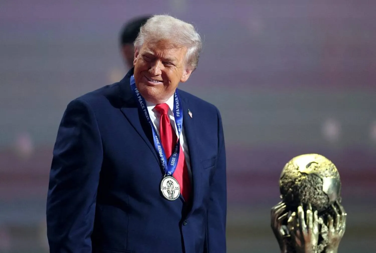 Football - FIFA World Cup 2026 - FIFA World Cup 2026 Draw - John F. Kennedy Center for the Performing Arts, Washington, DC, US - December 5, 2025 US President Donald Trump wears his medal as he is awarded the FIFA Peace Prize. (Reuters)