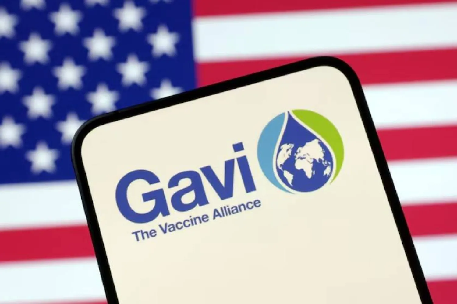 The Vaccine Alliance (GAVI) logo and US flag are seen in this illustration taken April 23, 2025. REUTERS/Dado Ruvic/Illustration/File Photo