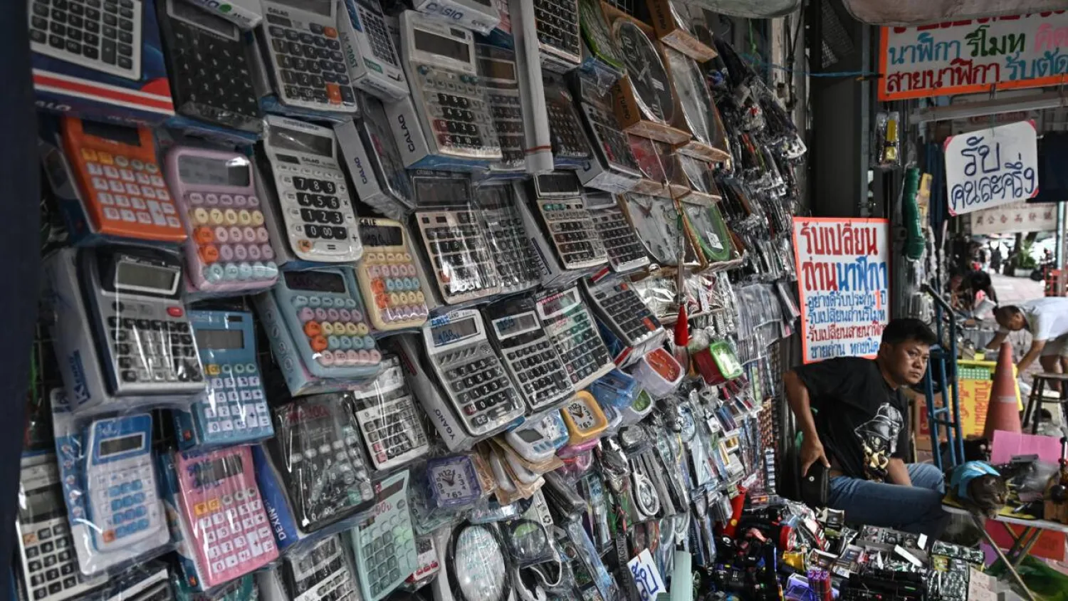 Calculators are more affordable than phones, and run on batteries and solar power. Lillian SUWANRUMPHA / AFP
