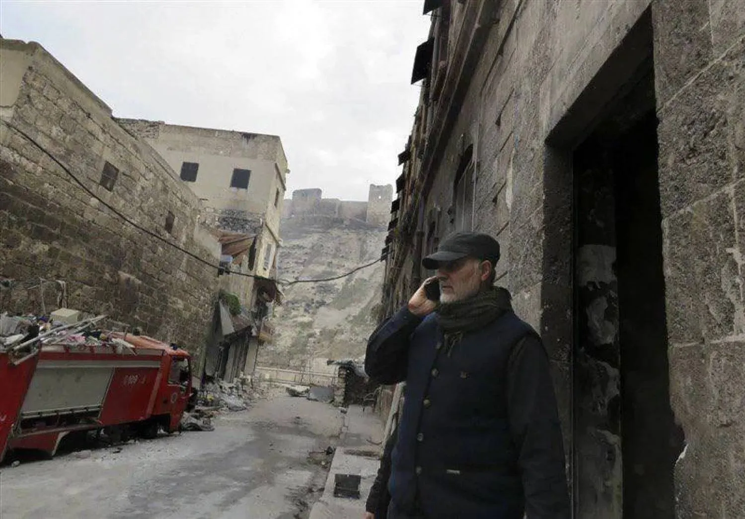 Iran's General Qassem Soleimani makes a phone call near the historic Citadel of Aleppo, winter 2016. (Fars) 