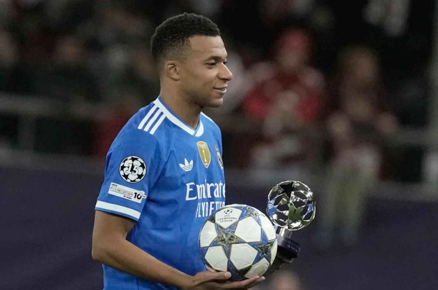 Real Madrid's Kylian Mbappe poses with the trophy after scoring four goal during the Champions League opening phase soccer match between Olympiacos and Real Madrid, in in Piraeus port, near Athens, Greece, Wednesday, Nov. 26, 2025. (AP Photo/Petros Giannakouris)