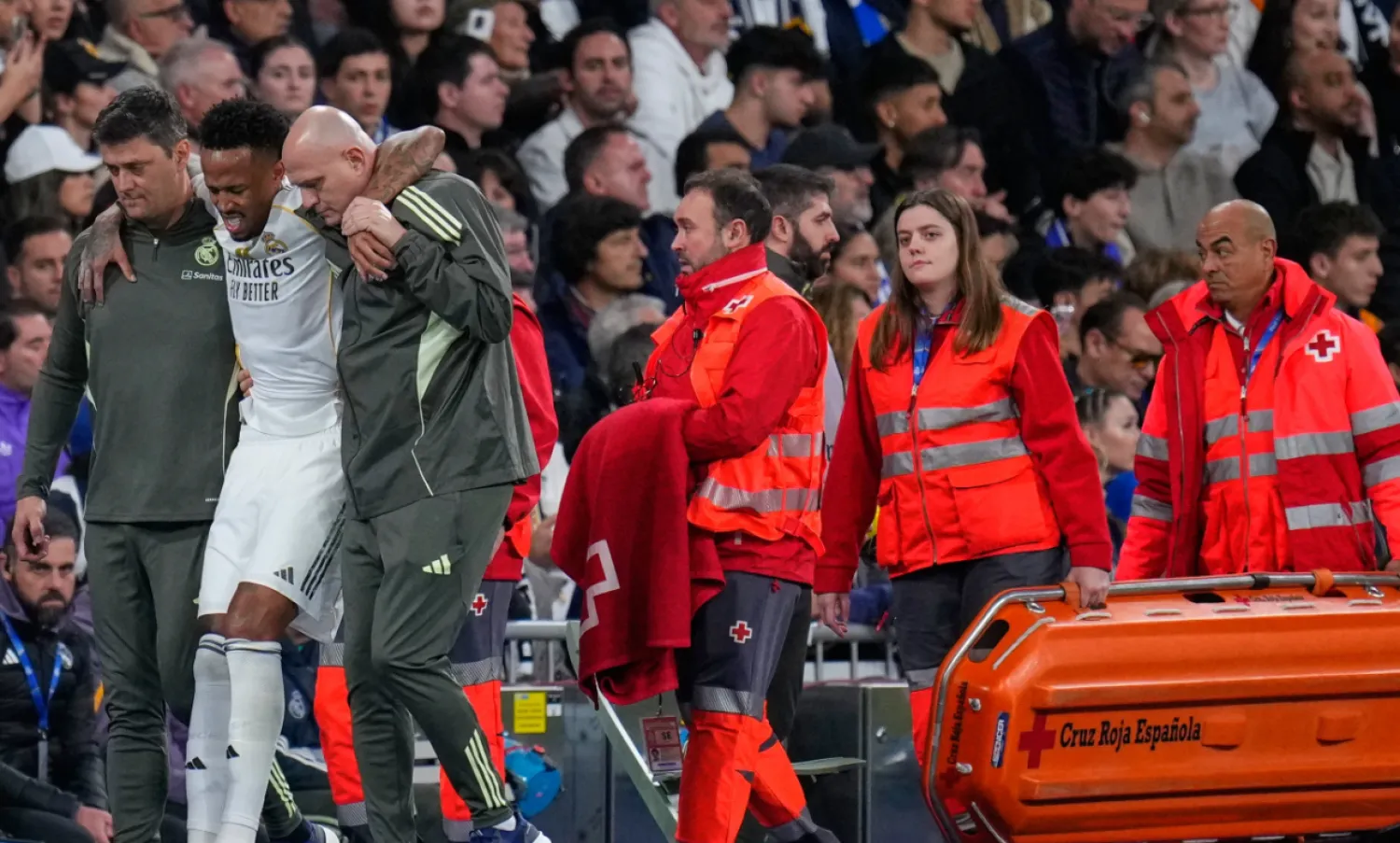 Real Madrid's Eder Militao is assisted from the pitch after getting an injury during the Spanish La Liga soccer match between Real Madrid and Celta Vigo in Madrid, Spain, Sunday, Dec. 7, 2025. (AP Photo/Manu Fernandez)