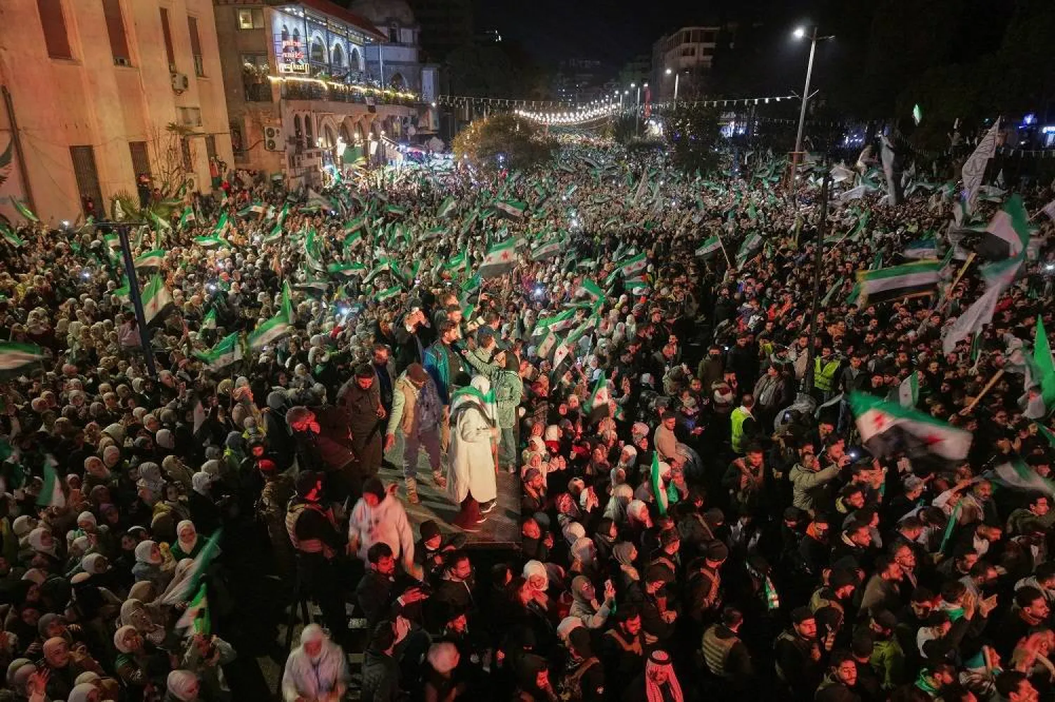 People fill Clock Square to mark the first anniversary of the ousting of the Bashar al-Assad regime. in Homs, western Syria, Monday, Dec. 8, 2025.(AP)