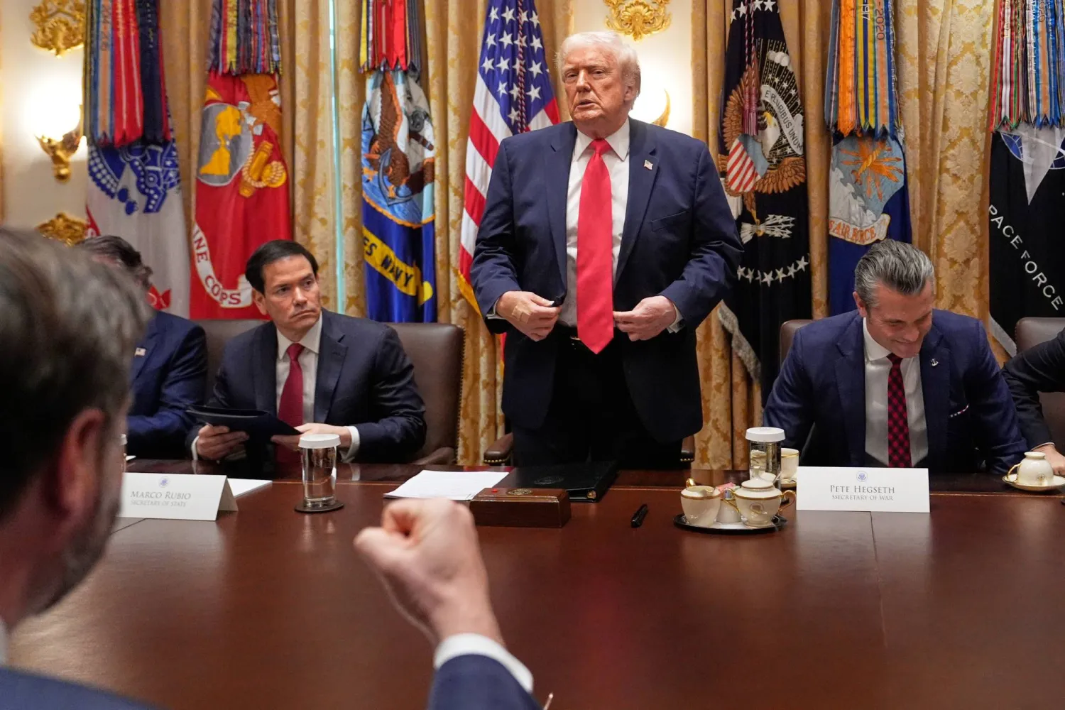 الرئيس الأميركي دونالد ترمب يتحدث في  اجتماع مجلس الوزراء بالبيت الأبيض بينما يظهر وزير الخارجية ماركو روبيو إلى يساره (أ.ب)
