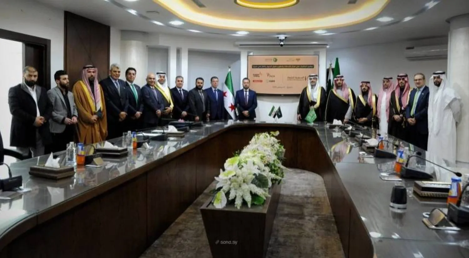 Saudi and Syrian officials are seen at Tuesday's signing ceremony. (SANA)