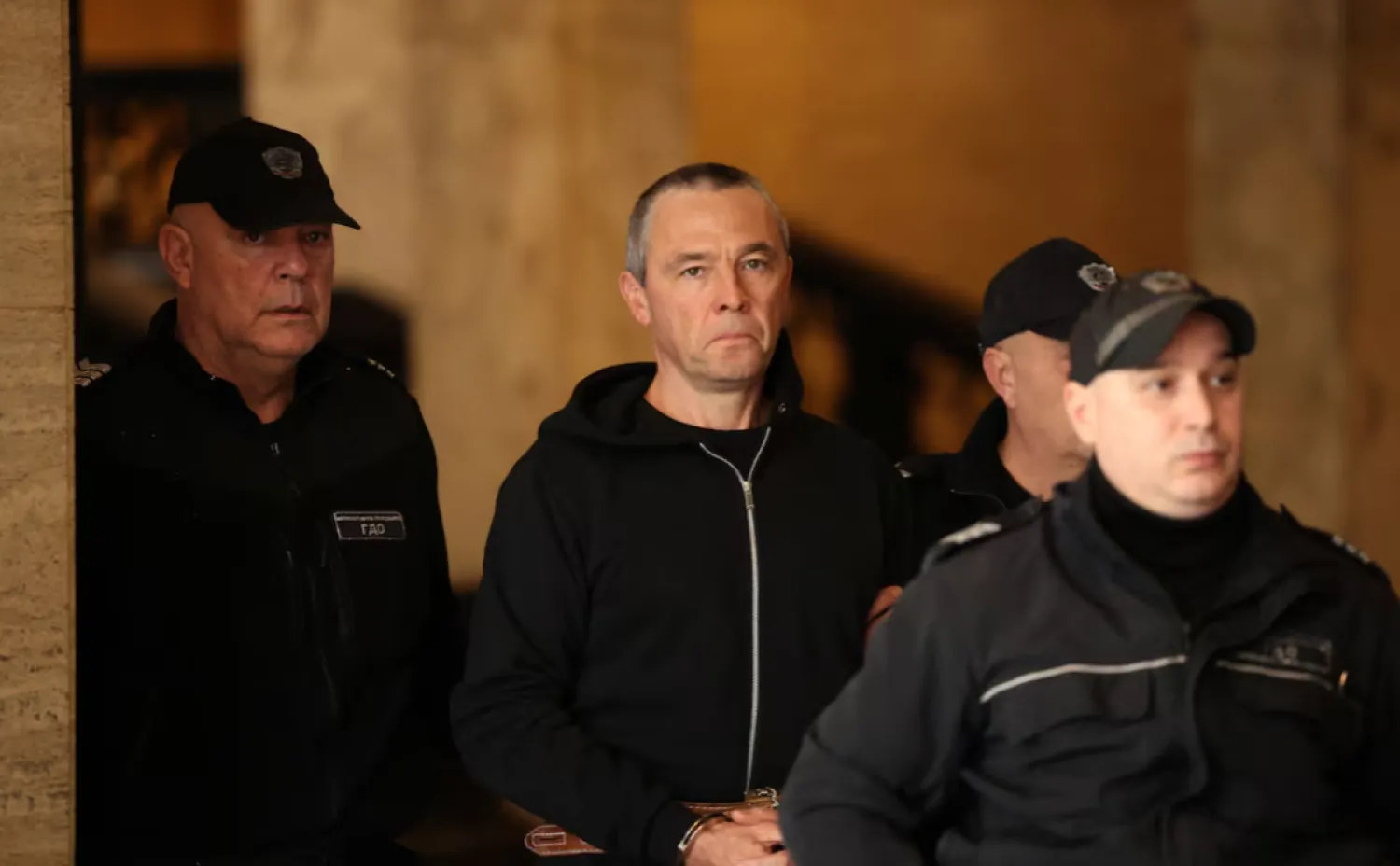 Igor Grechushkin, a Russian businessman based in Cyprus, is escorted by police before the start of his trial on the possible extradition to Lebanon, in Sofia, Bulgaria, December 10, 2025. REUTERS