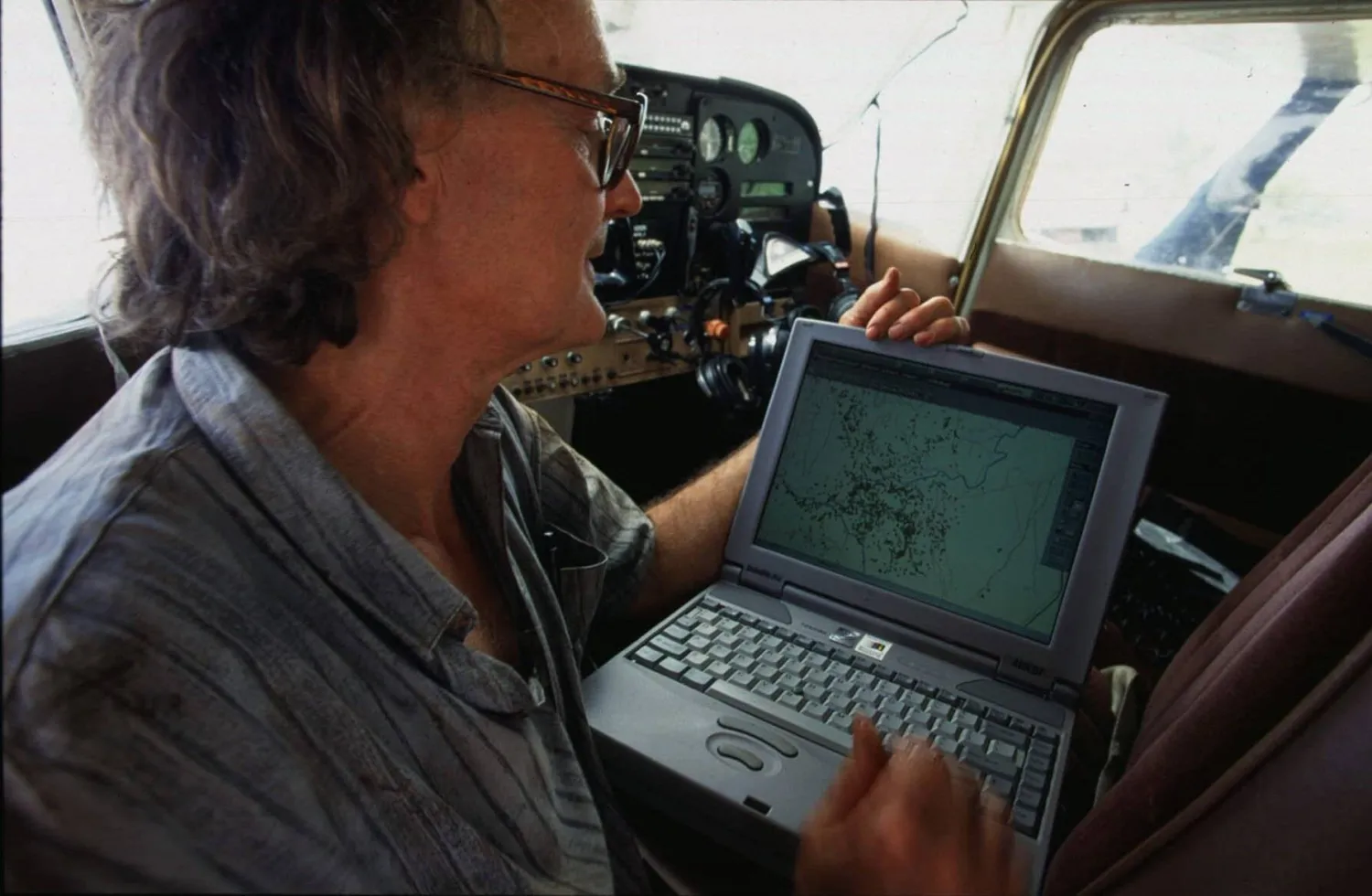 FILE - Dr. Iain Douglas-Hamilton checks on his laptop computer the position of an elephant fitted with a Global Positioning System (GPS) beacon in the Meru National Park, Kenya, May 21, 1998. (AP Photo/Jean-Marc Bouju, File)
