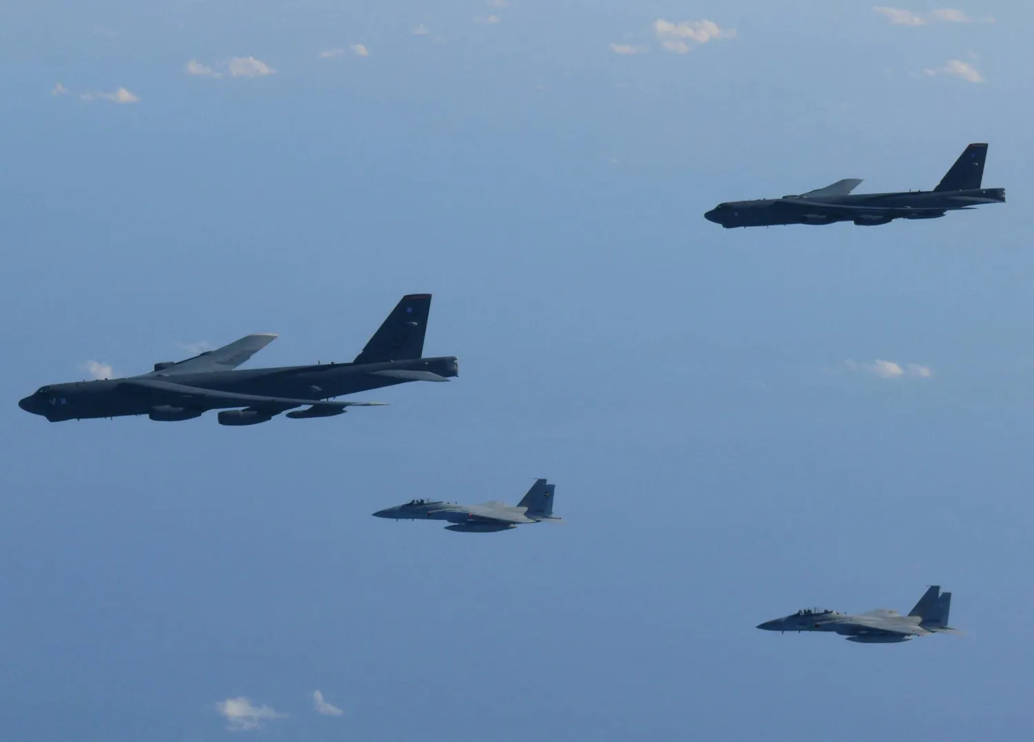 The 6th Air Wing of Japan Air Self-Defense Force's F-15 fighters hold a joint military drill with the US B-52 bombers over Sea of Japan, in this handout picture taken by Japan Air Self-Defense Force and on December 10, 2025, and released by the Joint Staff Office of the Defense Ministry of Japan on December 11, 2025. Joint Staff Office of the Defense Ministry of Japan/Handout via REUTERS     