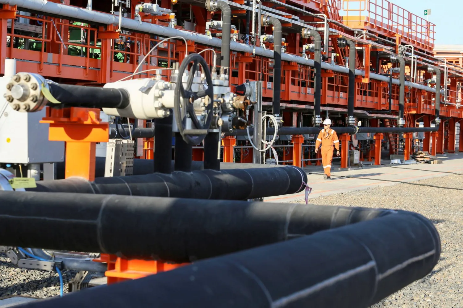 FILE PHOTO: A worker walks past infrastructure on D Island, the main processing hub, at the Kashagan offshore oil field in the Caspian sea in western Kazakhstan August 21, 2013.  REUTERS/Stringer/File Photo