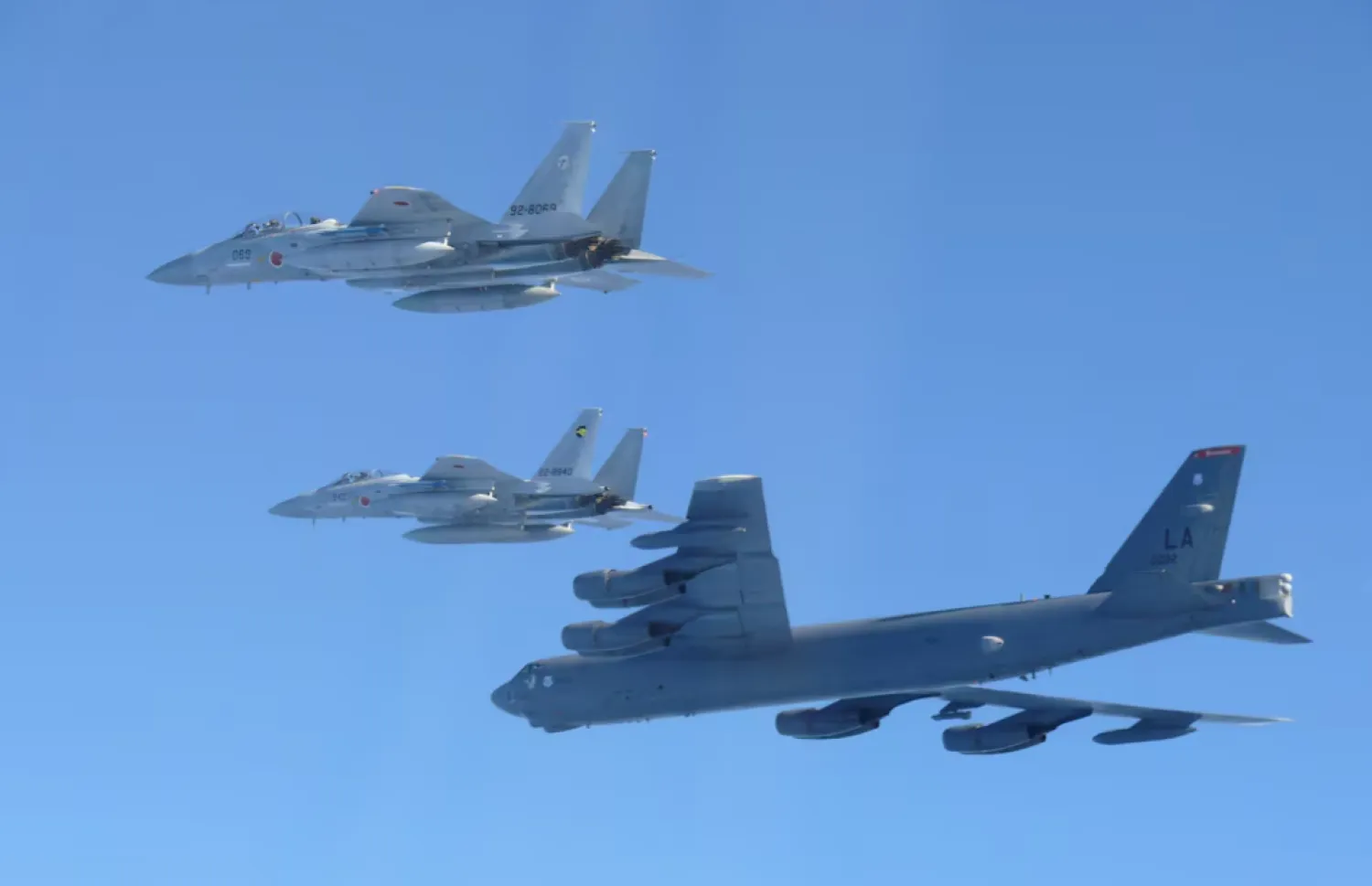 The 6th Air Wing of Japan Air Self-Defense Force's F-15 fighters hold a joint military drill with the US B-52 bomber over Sea of Japan, in this handout picture taken by Japan Air Self-Defence Force and on December 10, 2025, and released by the Joint Staff Office of the Defense Ministry of Japan - Reuters