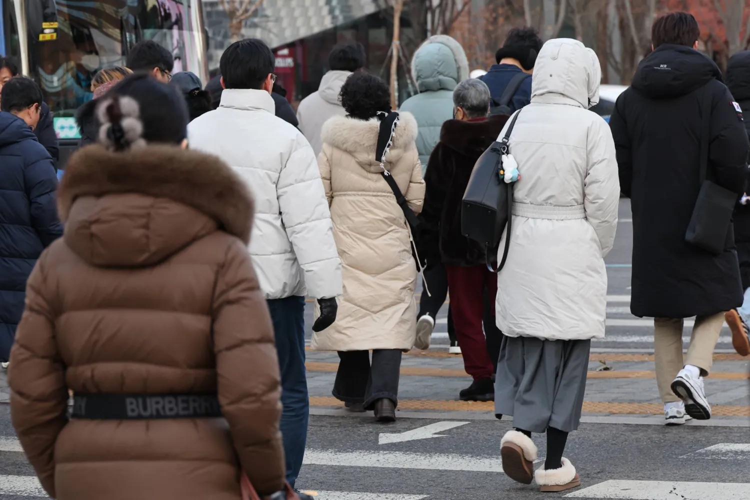 People wearing thick winter coats walk on Gwanghwamun Square in central Seoul, South Korea, 12 December 2025.  EPA/YONHAP