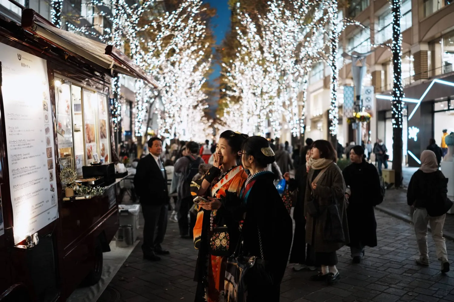People stroll along Marunouchi Naka-dori Street illuminated with winter lights Wednesday, Dec. 10, 2025, in Tokyo. (AP Photo/Eugene Hoshiko)