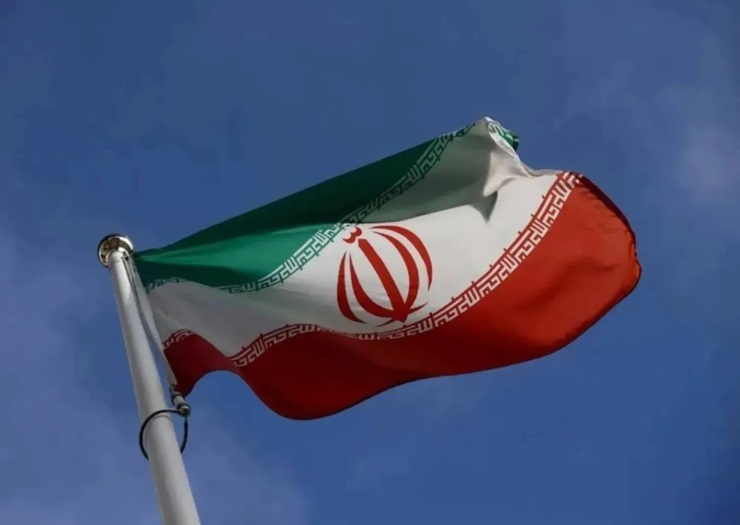 The Iranian flag waves in front of the International Atomic Energy Agency (IAEA) headquarters, before the beginning of a board of governors meeting, amid the coronavirus disease (COVID-19) outbreak in Vienna, Austria, March 1, 2021. (Reuters)
