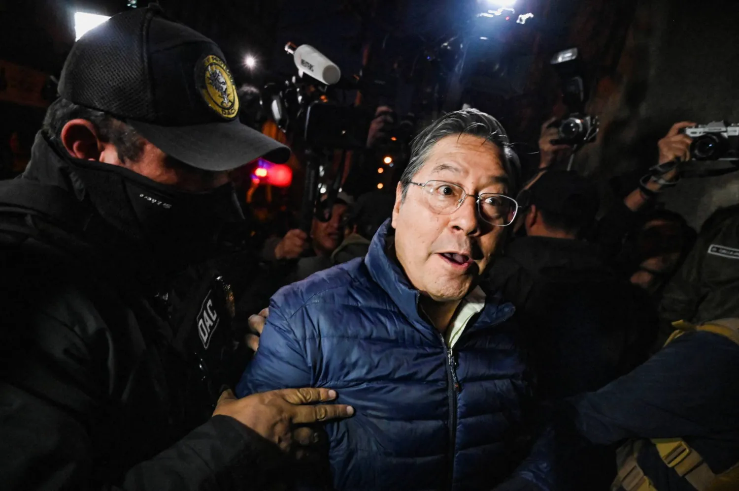 Former Bolivian President Luis Arce Catacora enters San Pedro prison after a judge ordered him held in pre-trial detention for five months as part of an investigation into alleged embezzlement, in La Paz, Bolivia, December 12, 2025. REUTERS/Claudia Morales