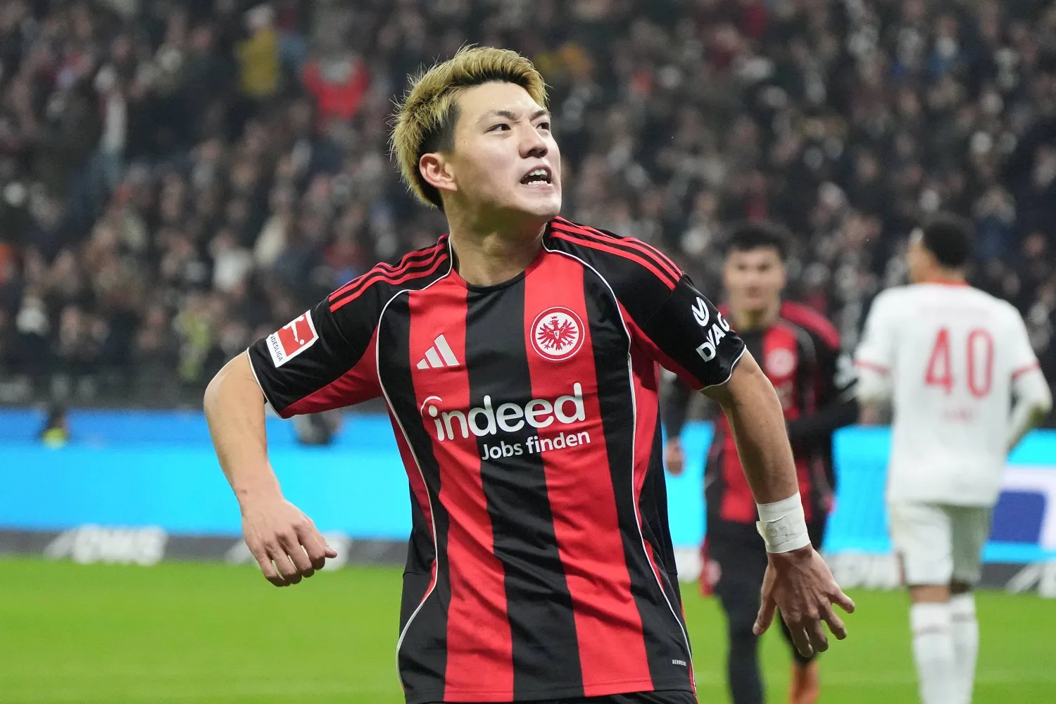 13 December 2025, Hesse, Frankfurt/M.: Eintracht Frankfurt's Ritsu Doan celebrates scoring his side's first goal during the German Bundesliga soccer match between Eintracht Frankfurt and FC Augsburg at Deutsche Bank Park. (dpa)