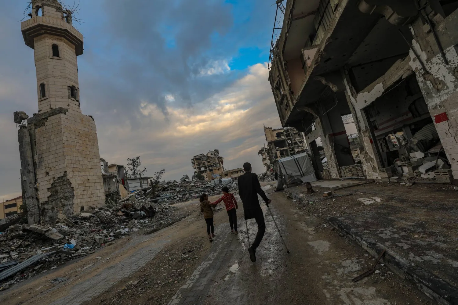A Palestinian amputee walks in Yafa street among the destroyed Al Mahata mosque and destroyed buildings, in Al Tuffah neighborhood, east of Gaza City, 13 December 2025, near the yellow line amid a ceasefire between Israel and Hamas. EPA/MOHAMMED SABER