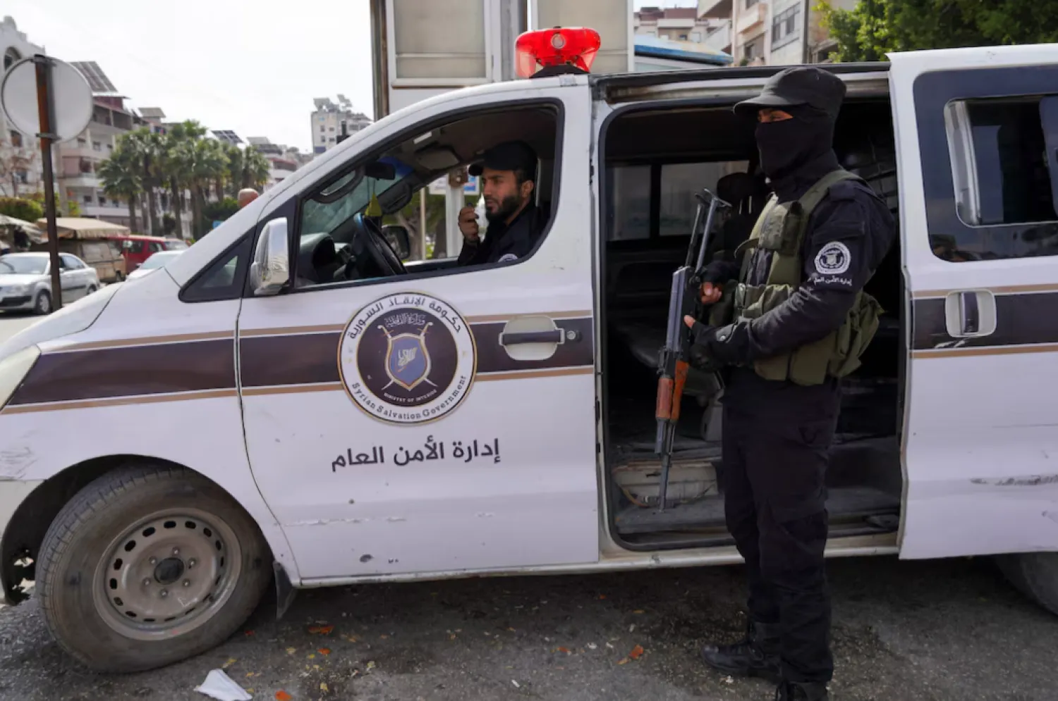 Members of the Syrian security forces secure an area -REUTERS/Karam al-Masri