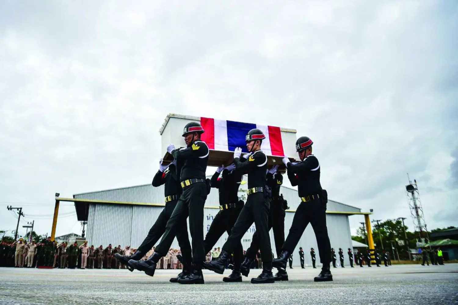 TOPSHOT - Soldiers carry the coffin of Special Forces volunteer Mustakim Majehma, who died amid clashes along Cambodia-Thailand border, during a military ceremony at Narathiwat airport in Thailand's southern province of Narathiwat on December 14, 2025. (Photo by Madaree TOHLALA / AFP)