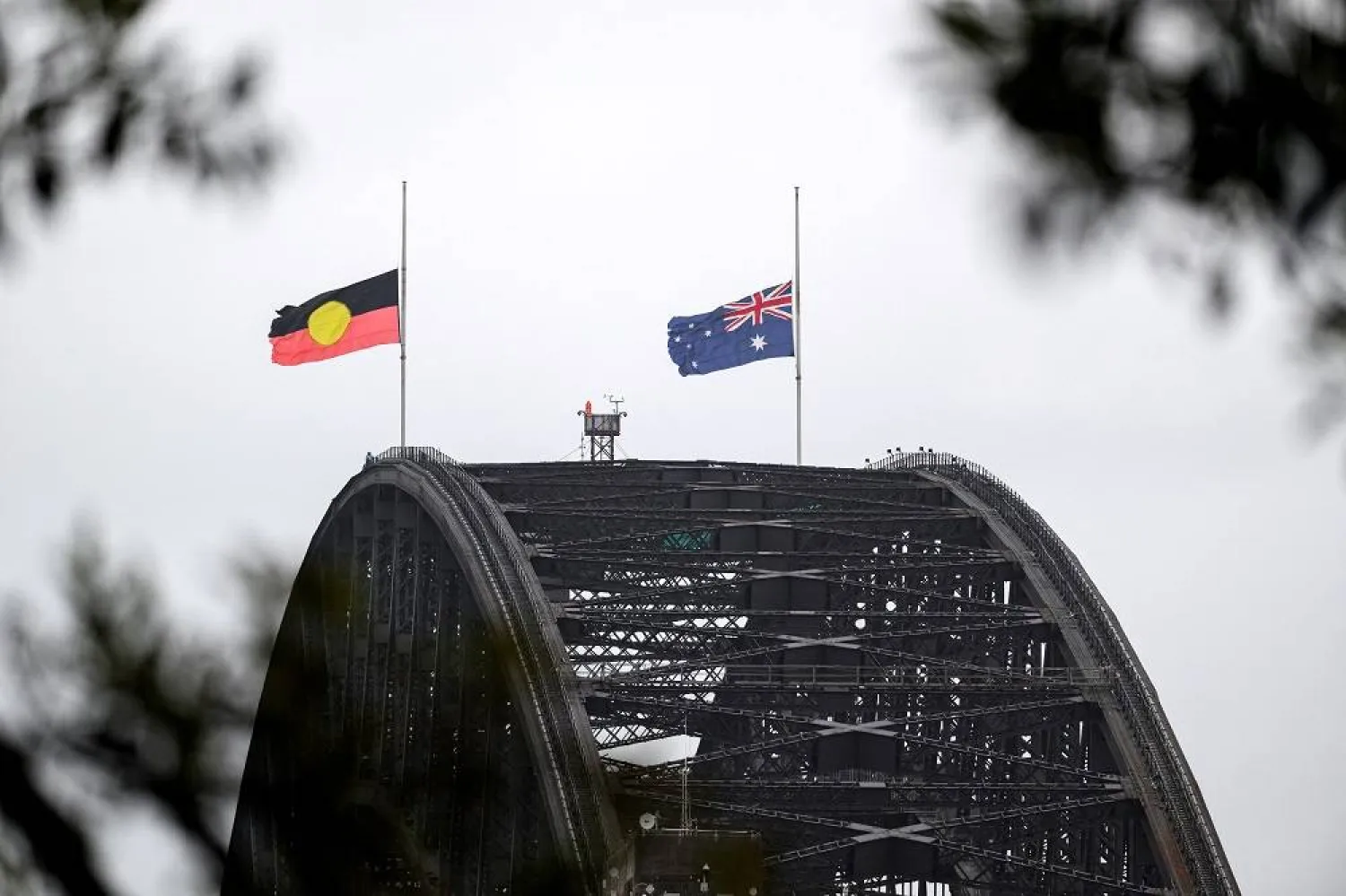 Flags fly at half-mast on the Sydney Harbor Bridge in Sydney, Australia, December 15, 2025. (AAP/Steven Markham via Reuters) 