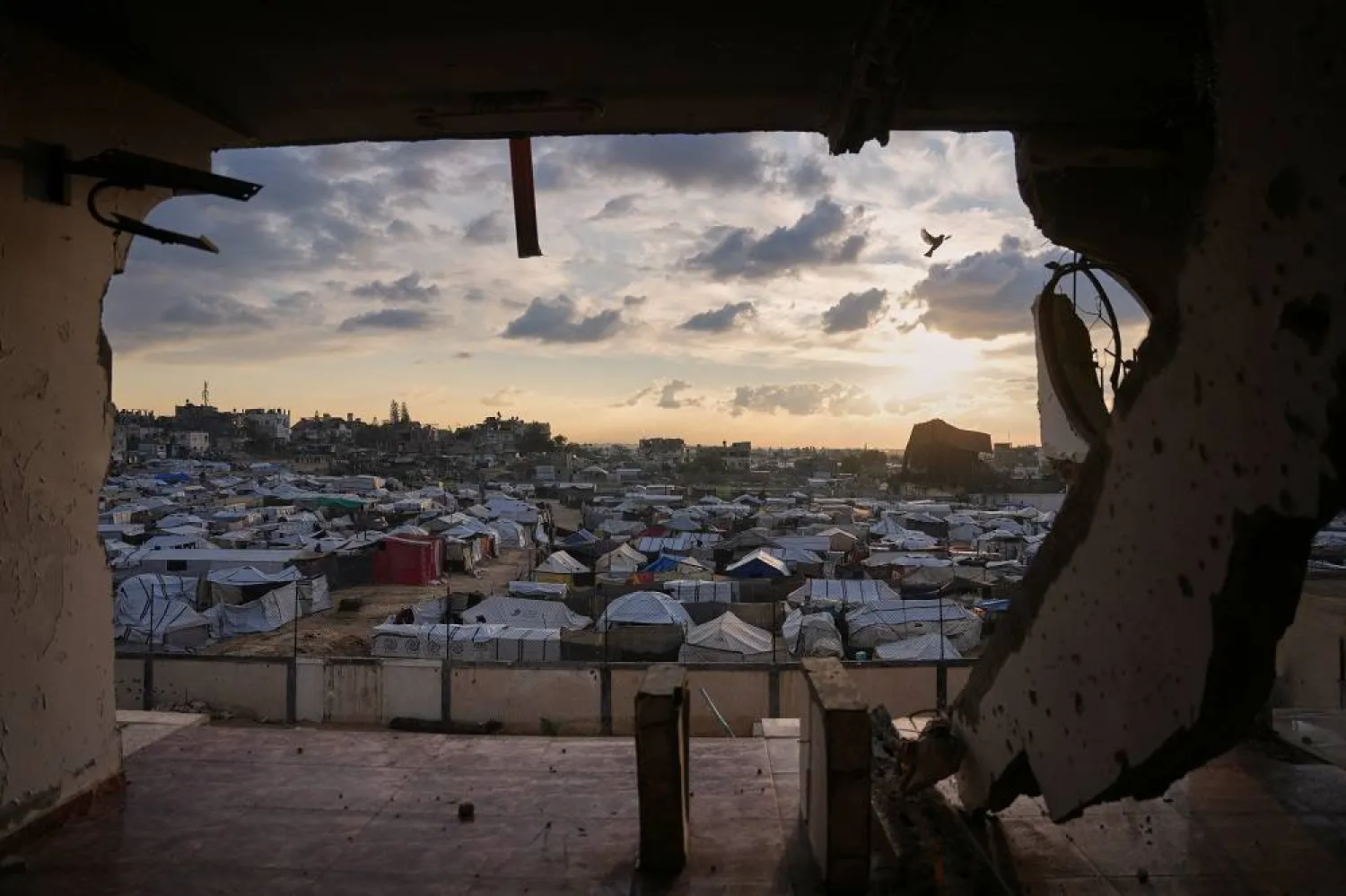Seen from a building heavily damaged during the Israeli air and ground operations, tents fill a makeshift camp for displaced Palestinians in Deir al-Balah, central Gaza Strip, Saturday, Dec. 13, 2025. (AP)