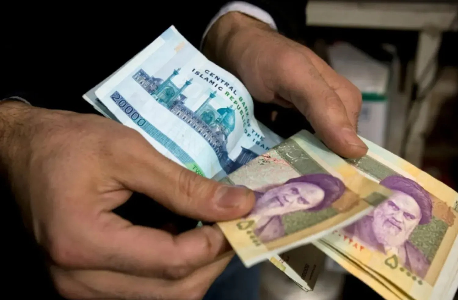 An Iranian trader counts money in Tehran's Grand Bazaar. (Reuters)
