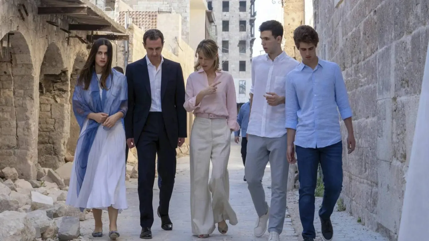 Bashar al-Assad with his wife, Asma, walk with their children in the northern Syrian city of Aleppo in 2022. (Former Syrian presidency Facebook page/AFP/Getty Images) 