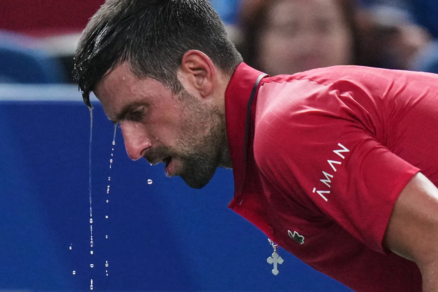 Novak Djokovic of Serbia cools himself with water during the men's singles semifinal match with Valentin Vacherot of Monaco, at the Shanghai Masters tennis tournament at Qizhong Forest Sports City Tennis Center, in Shanghai, China, Saturday, Oct. 11, 2025. (AP)