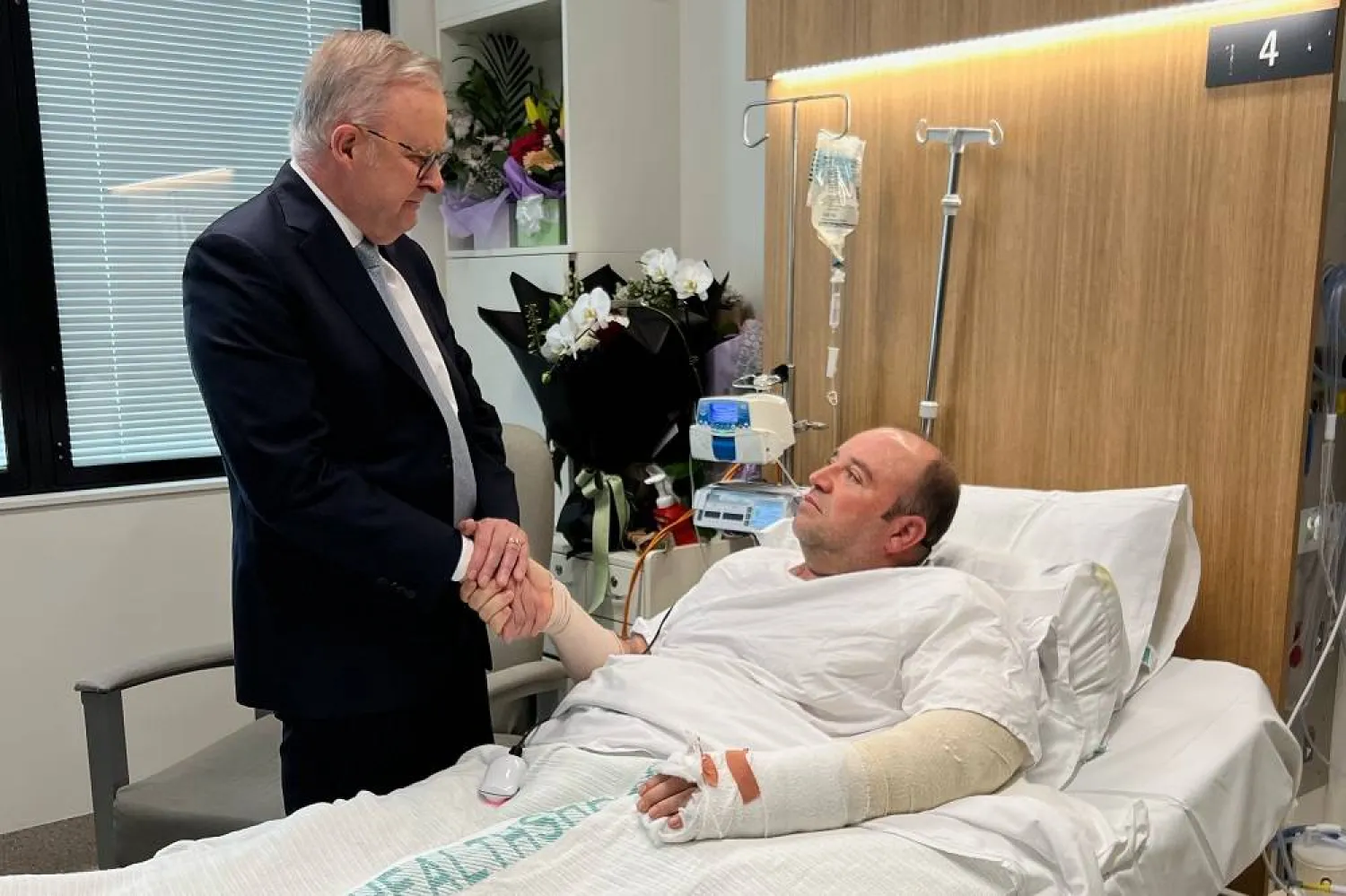 In this photo released by the Prime Minister office, Australian Prime Minister Anthony Albanese meets Ahmed al Ahmed at St George Hospital in Sydney, Tuesday, Dec. 16, 2025. (Australian Prime Minister Office via AP)