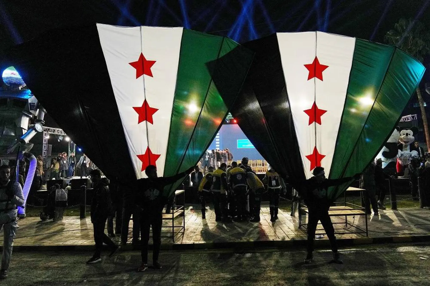 Syrian citizens wave their national flags during celebrations marking the first anniversary of the ousting of former President Bashar al-Assad in Damascus, Syria, Monday, Dec. 8, 2025. (AP)