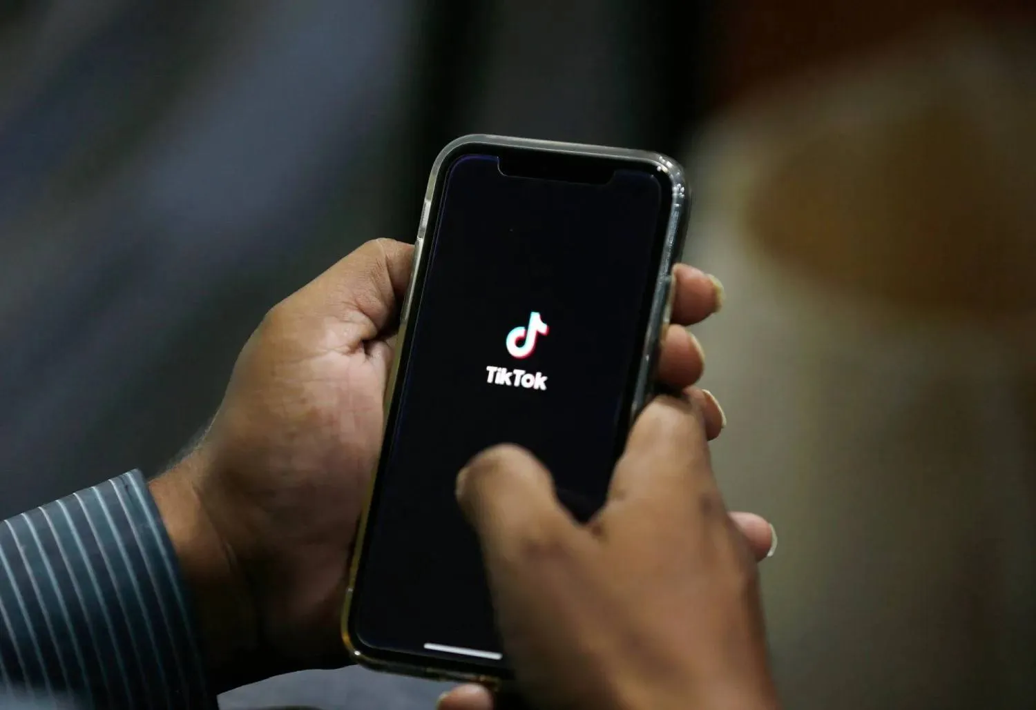 FILE – In this July 21, 2020 file photo, a man opens social media app ‘TikTok’ on his cell phone, in Islamabad, Pakistan. (AP Photo/Anjum Naveed, File) 