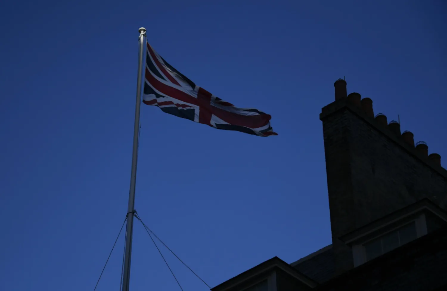 FILE - In this file photo dated Monday, Dec. 14, 2020, the Union Flag flies on the top of 10 Downing Street, the Prime Minister's official residence in London. (AP Photo/Alberto Pezzali, FILE)