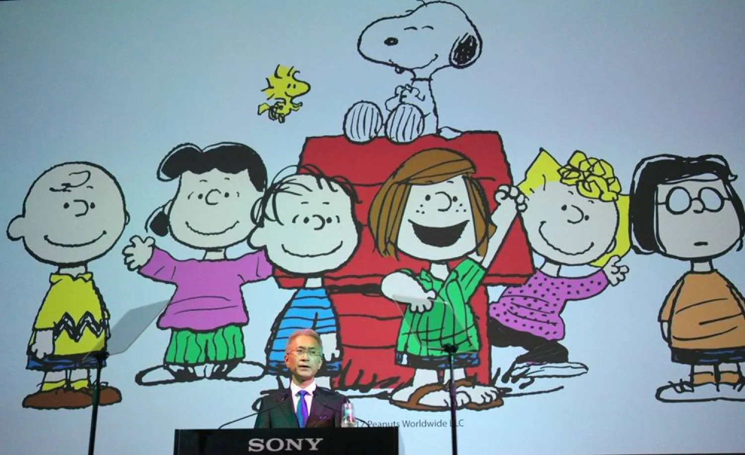 Sony Corp. President Kenichiro Yoshida speaks as characters from "Peanuts" are shown at a press conference at the company's headquarters Tuesday, May 22, 2018, in Tokyo. (AP)