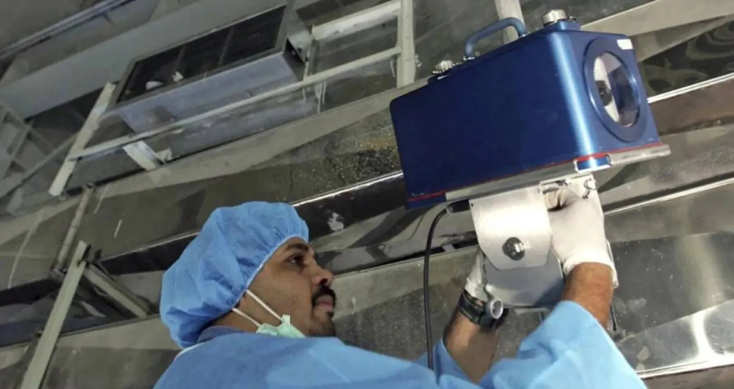 An inspector of the International Atomic Energy Agency sets up surveillance equipment at a uranium conversion facility in Iran in 2005. Photograph: Mehdi Ghasemi/AP