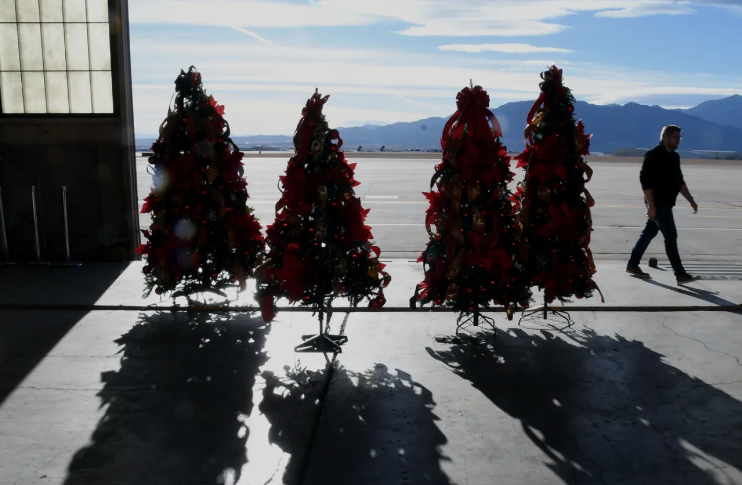 Christmas trees are displayed inside a hangar at Peterson Space Force Base in Colorado Springs, Colo., on Thursday, Dec. 18, 2025 in advance of the annual NORAD Tracks Santa Operation, at the North American Aerospace Defense Command. (AP Photo/Thomas Peipert)

