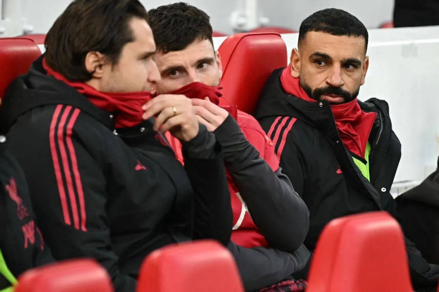  Liverpool's Egyptian striker #11 Mohamed Salah (R) sits on the bench during the English Premier League football match between Liverpool and Brighton and Hove Albion at Anfield in Liverpool, north west England on December 13, 2025. (Photo by Paul ELLIS / AFP) 