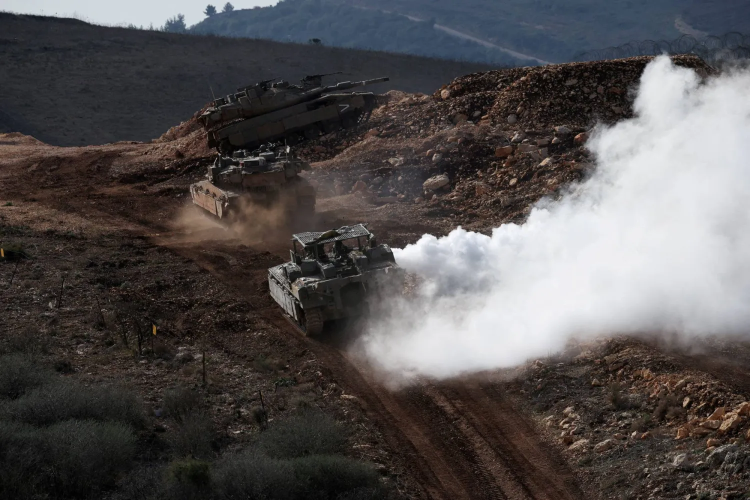 FILE PHOTO: Israeli military vehicles manoeuvre along the Israel-Lebanon border, as seen from northern Israel, November 24, 2025. REUTERS/Shir Torem/File Photo
