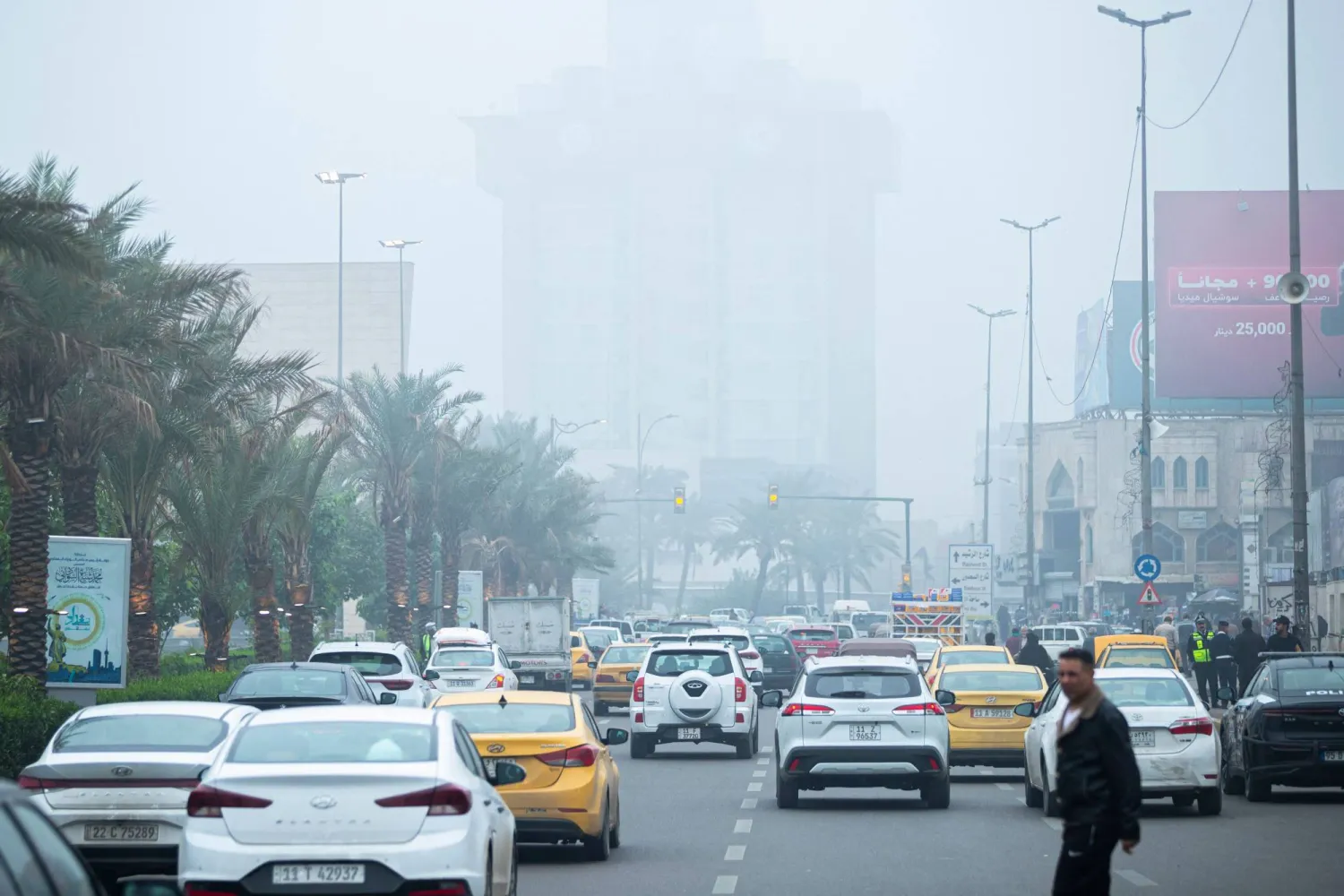 Cars drive through central Baghdad as a thick fog blankets the Iraqi capital on December 11, 2025. (AFP)