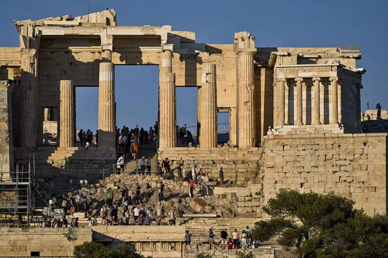 Tourists descent Propylaia, the ancient gate of the Acropolis archaeological site in Athens on June 21, 2023. (AFP) 