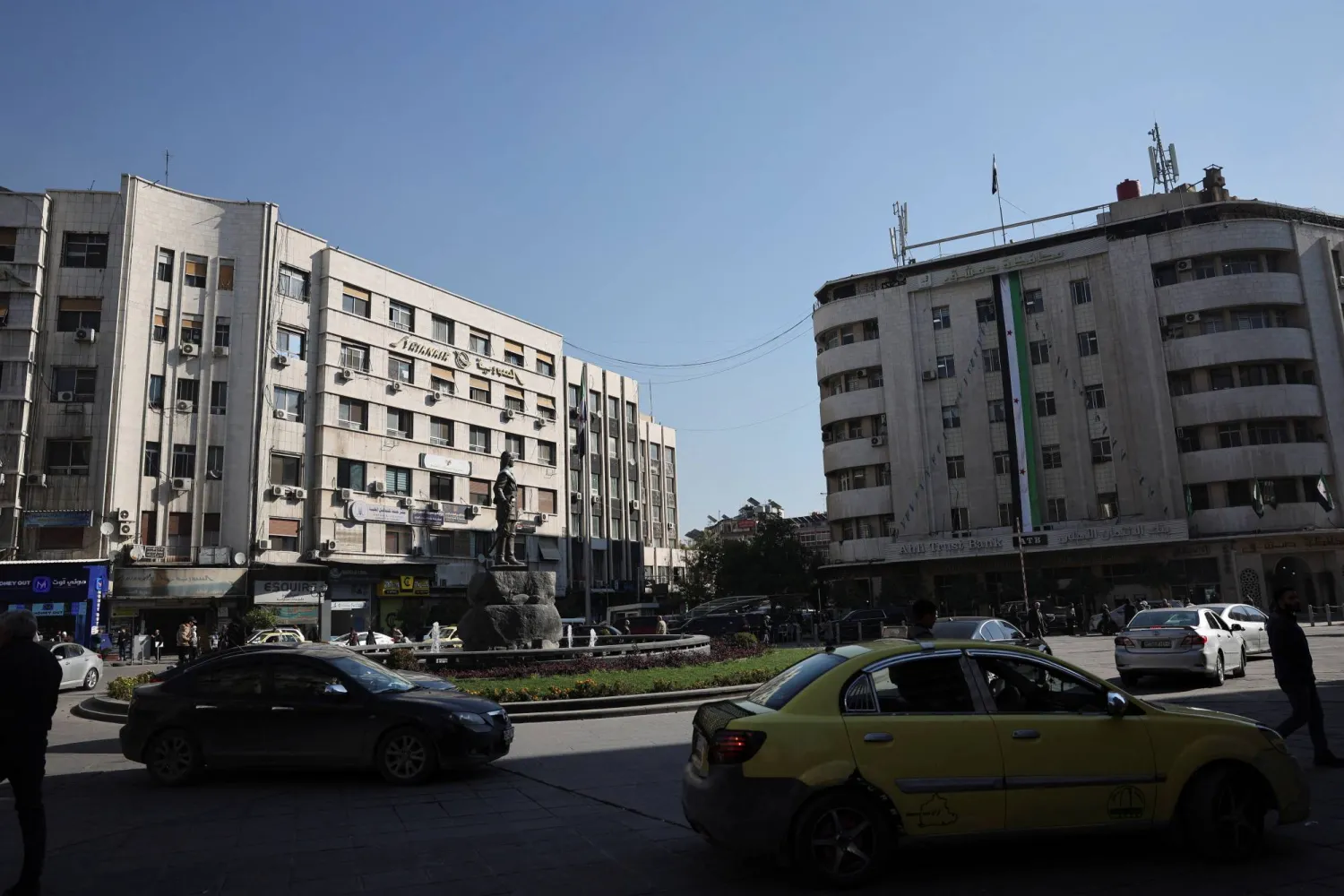 People walk along a street in Damascus, Syria, December 18, 2025. REUTERS/Khalil Ashawi 
