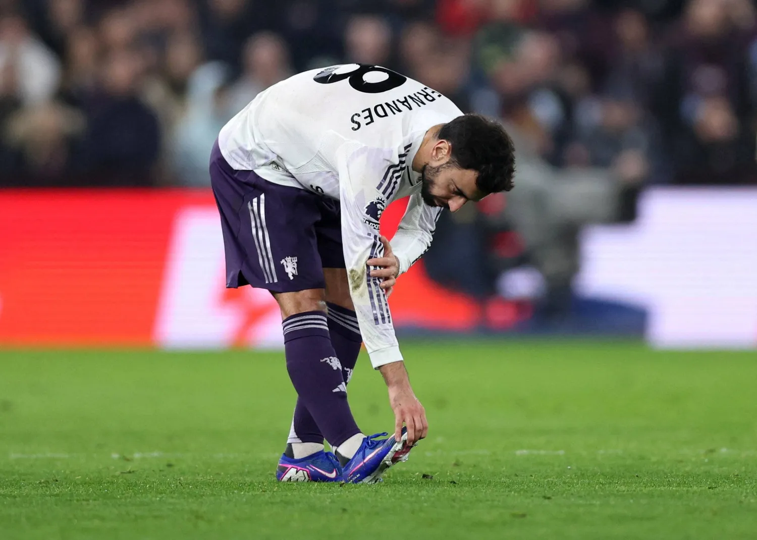 Football - Premier League - Aston Villa v Manchester United - Villa Park, Birmingham, Britain - December 21, 2025 Manchester United's Bruno Fernandes reacts after sustaining an injury. (Reuters)