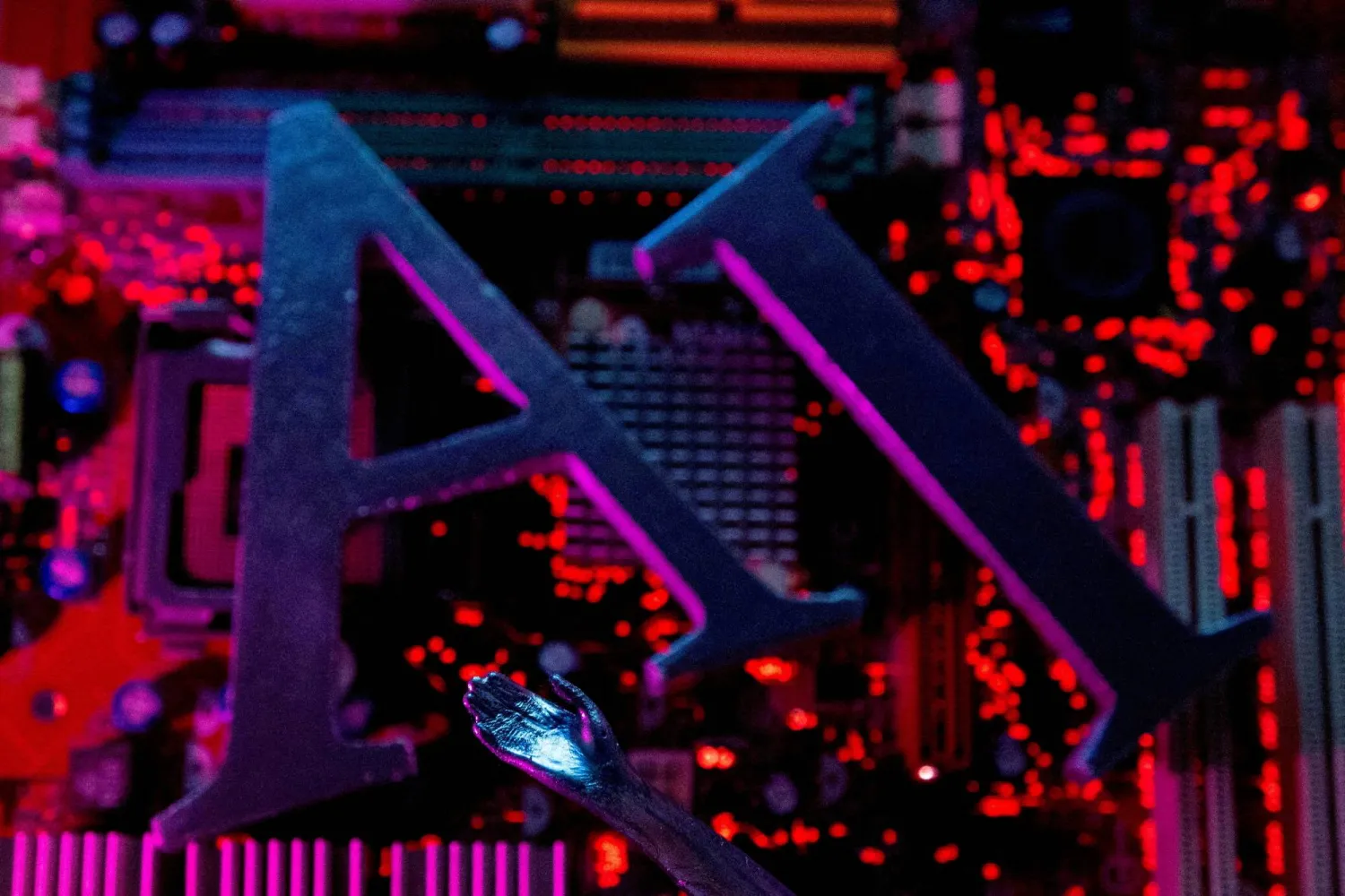 FILE PHOTO: AI (Artificial Intelligence) letters and robot hand are placed on computer motherboard in this illustration created on June 23, 2023. REUTERS/Dado Ruvic/Illustration/File Photo