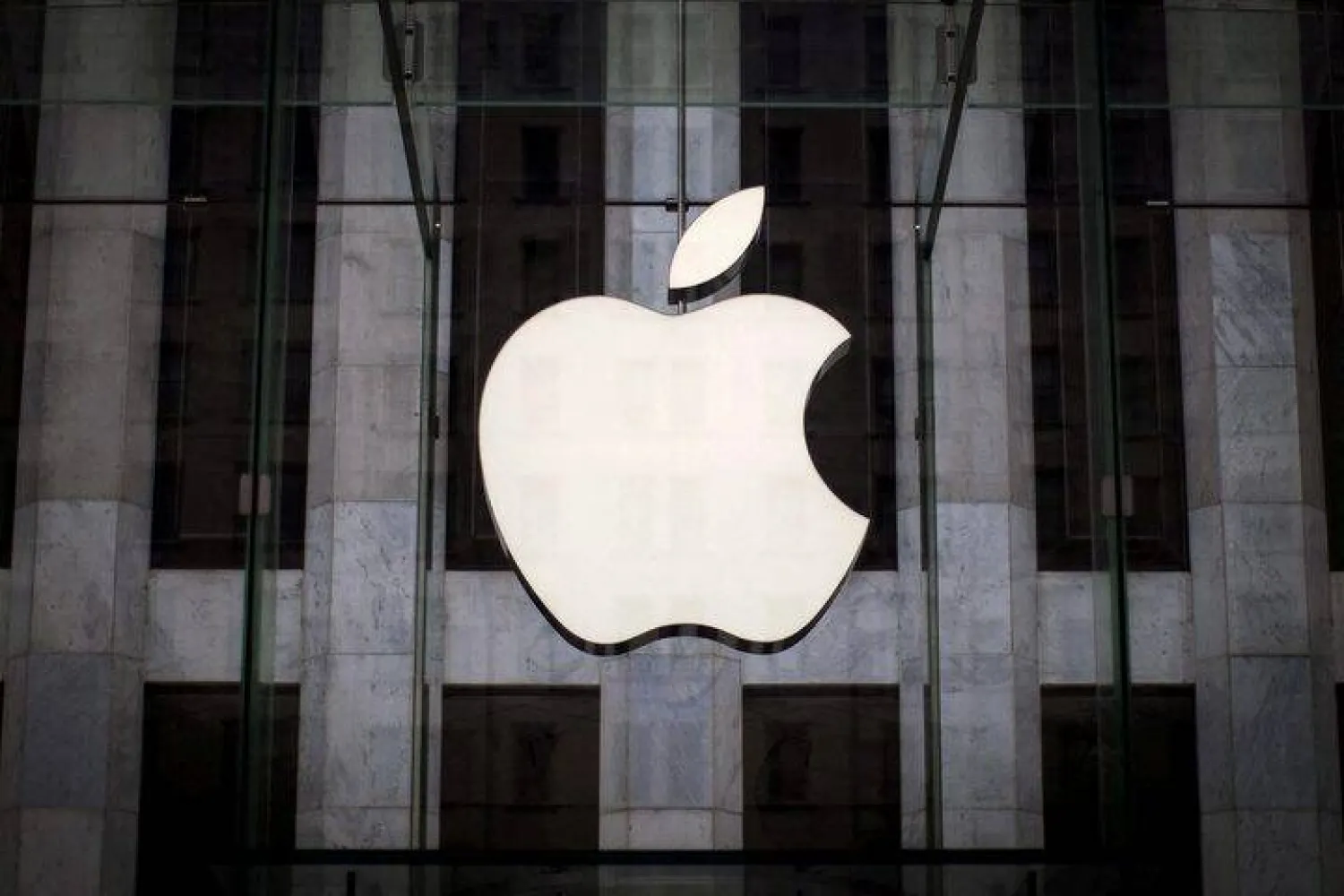 An Apple logo hangs above the entrance to the Apple store on 5th Avenue in the Manhattan borough of New York City, July 21, 2015. REUTERS/Mike Segar/File Photo Purchase Licensing Rights