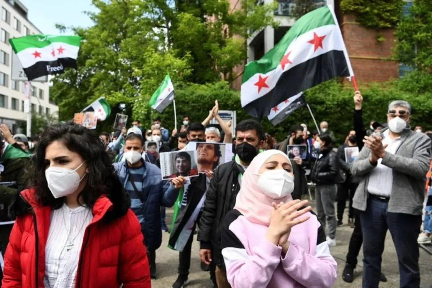 People attend a protest against reelection of Syria's president Bashar al-Assad, near Syria's embassy, Berlin, Germany May 26, 2021. (Reuters)
