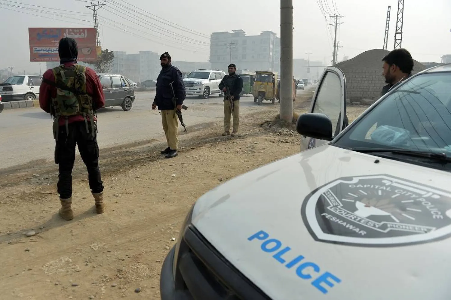 Pakistani security officials stand guard at a checkpoint on the eve of Christmas in Peshawar, Pakistan, 24 December 2025. (EPA)