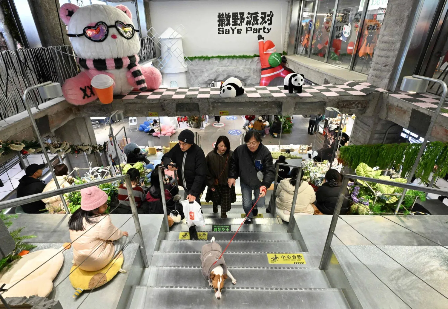 People visit a shopping center in Beijing on December 20, 2025. (AFP)